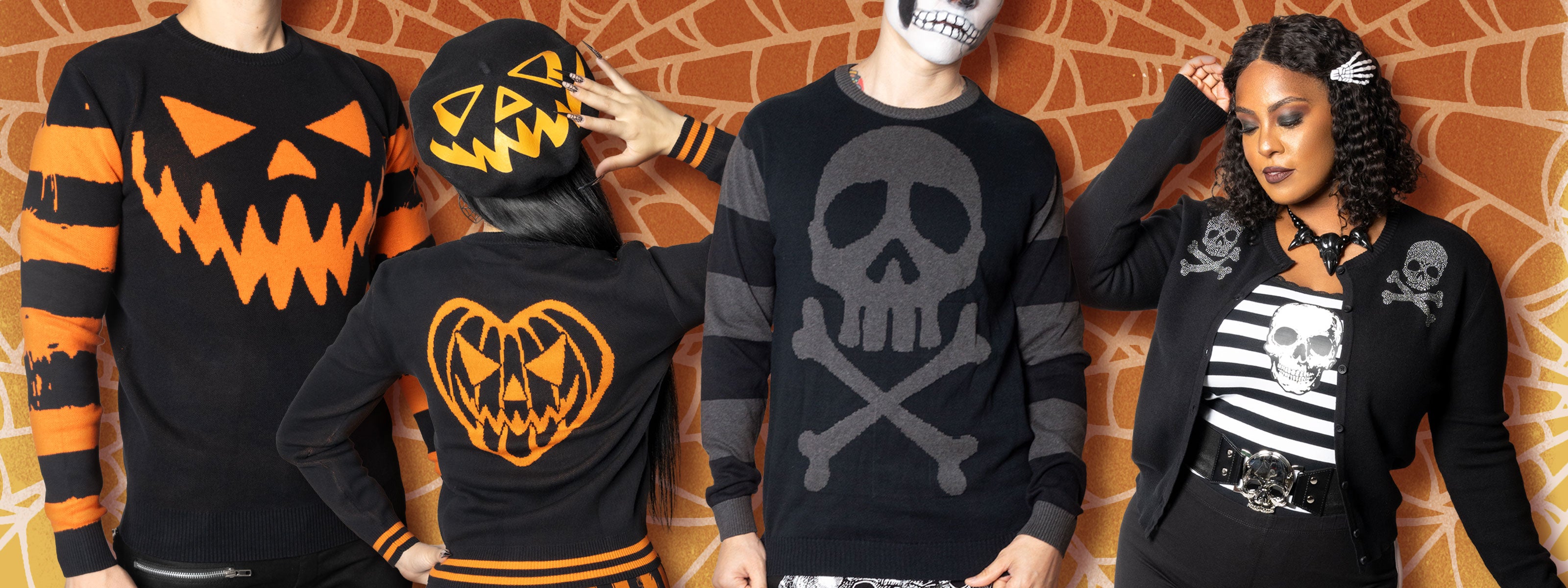 People wearing skull and pumpkin clothing against a spider web background